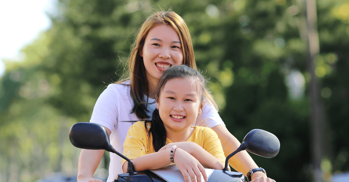 solo parent with her daughter riding a bicycle- solo parent benefits